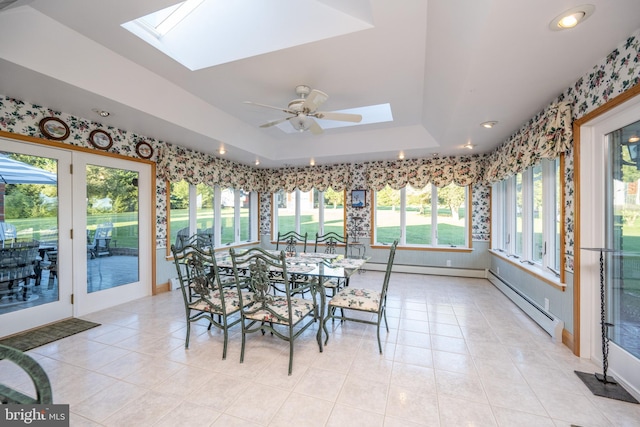 sunroom / solarium featuring baseboard heating, a wealth of natural light, and a skylight