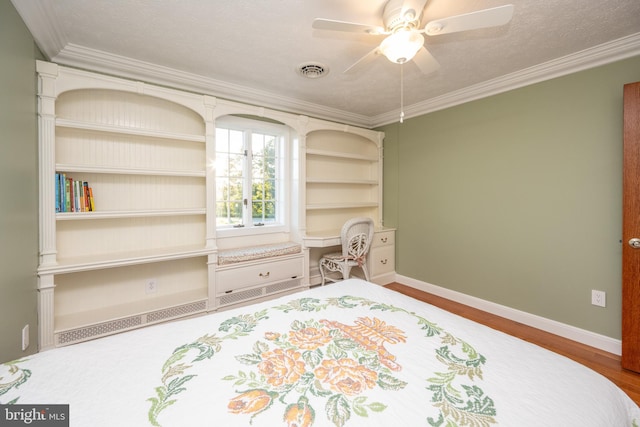 bedroom with ornamental molding, hardwood / wood-style floors, a textured ceiling, and ceiling fan