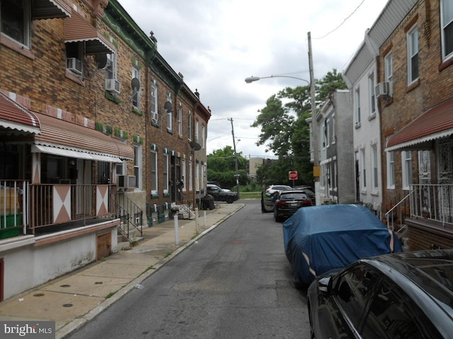 2415 N Myrtlewood St, Philadelphia, PA 19132 - view of asphalt street with street lighting, sidewalks, curbs, and traffic signs