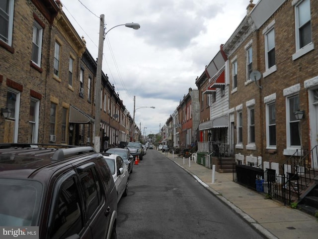 2415 N Myrtlewood St, Philadelphia, PA 19132 - view of asphalt road with street lights, a residential view, sidewalks, and curbs