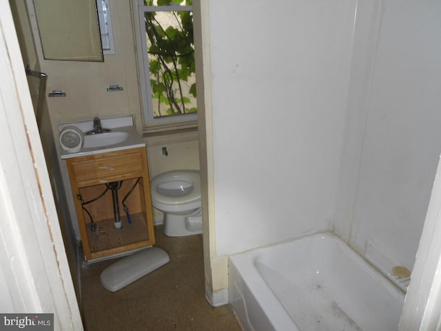 bathroom with toilet, vanity, and a tub