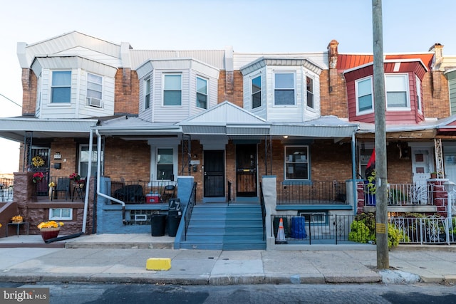 multi unit property featuring cooling unit and covered porch