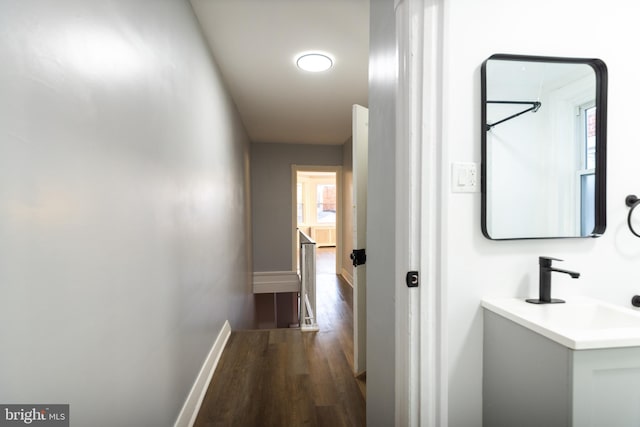 hall featuring dark hardwood / wood-style floors and sink