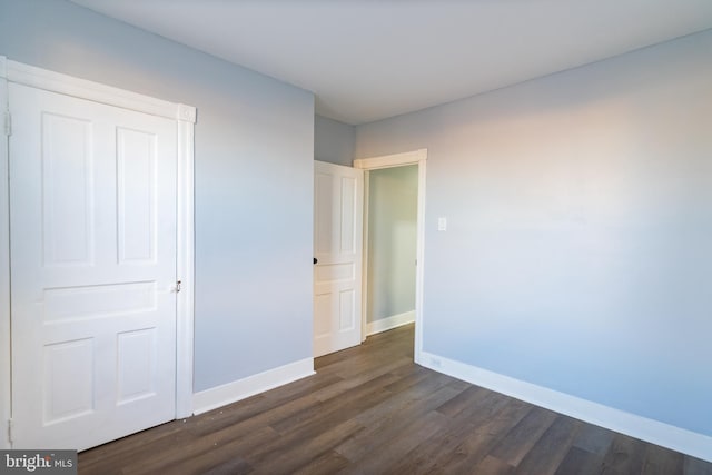 unfurnished bedroom featuring dark hardwood / wood-style floors