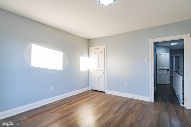 unfurnished bedroom featuring dark wood-type flooring