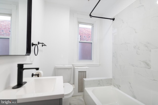 full bathroom featuring toilet, tiled shower / bath combo, and vanity