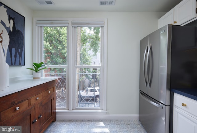2009 Hillyer Pl NW, Washington, DC 20009 - kitchen with freestanding refrigerator, dark aggregate flooring, and white cabinetry