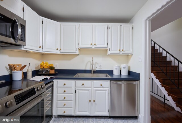 2009 Hillyer Pl NW, Washington, DC 20009 - kitchen featuring stainless steel appliances, dark countertops, and white cabinets