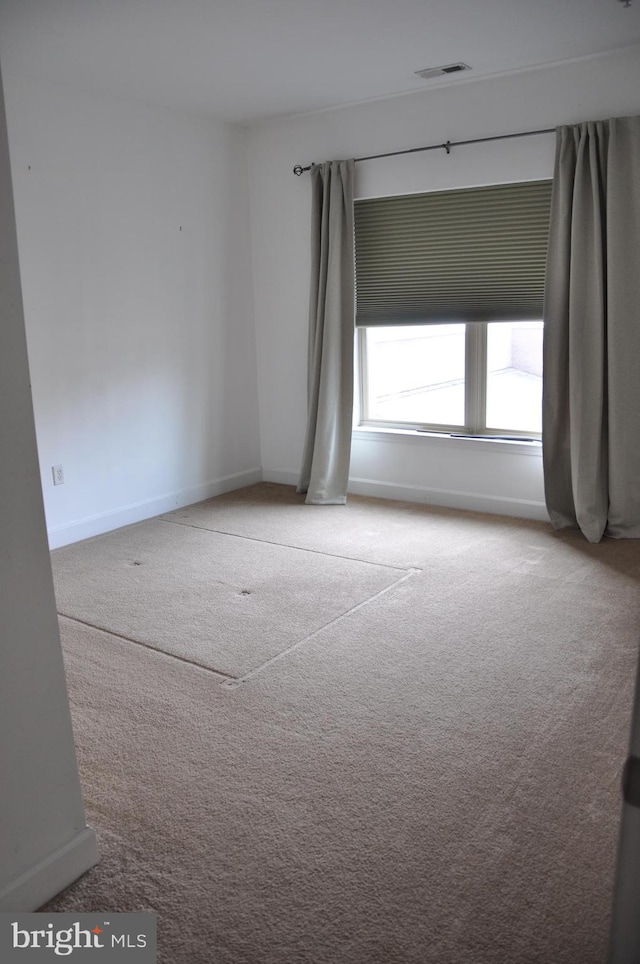 empty room featuring light colored carpet