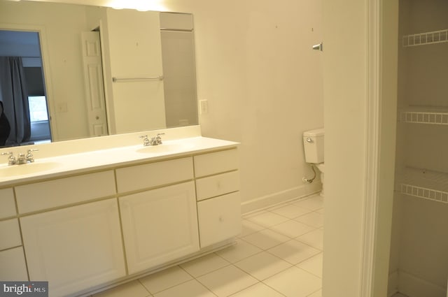 bathroom featuring vanity, toilet, and tile patterned floors