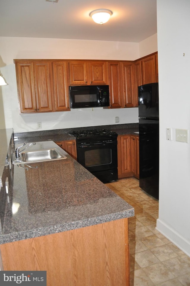 kitchen with kitchen peninsula, sink, and black appliances