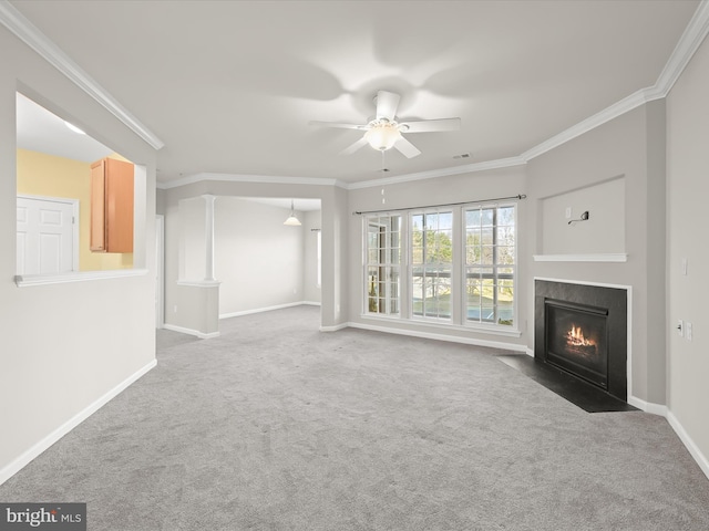 unfurnished living room featuring carpet flooring, ceiling fan, and ornamental molding