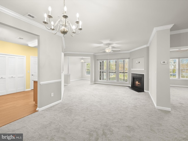 unfurnished living room with ceiling fan with notable chandelier, light colored carpet, and ornamental molding