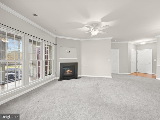 unfurnished living room with ceiling fan, carpet floors, and ornamental molding