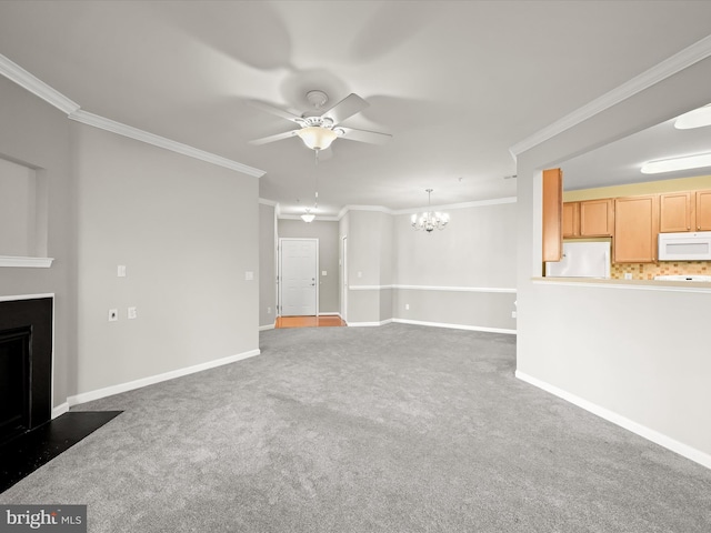 unfurnished living room with ceiling fan with notable chandelier, dark carpet, and crown molding