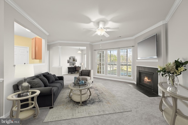 carpeted living room featuring ceiling fan and crown molding