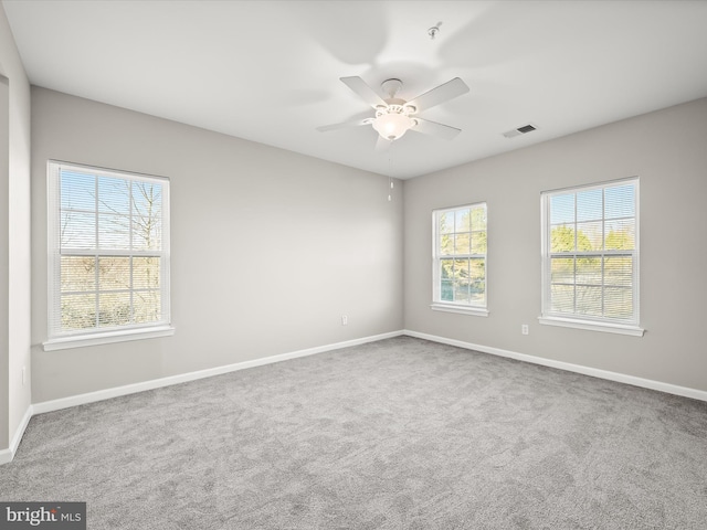 spare room featuring carpet flooring and ceiling fan