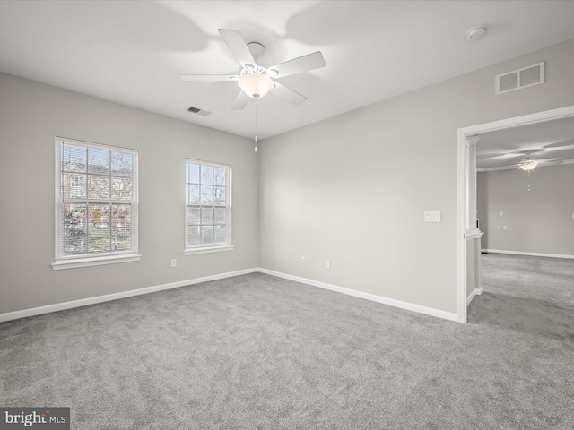 carpeted empty room featuring ceiling fan