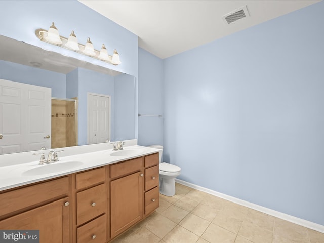 bathroom with toilet, vanity, tile patterned floors, and an enclosed shower