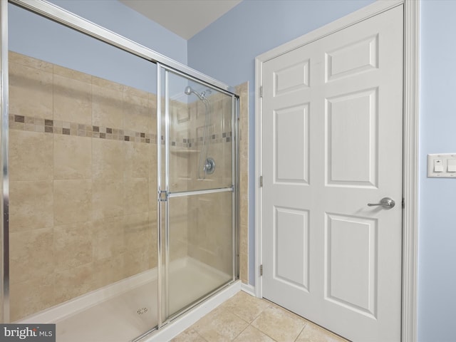 bathroom with tile patterned flooring and an enclosed shower