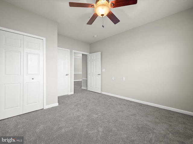 unfurnished bedroom featuring carpet floors, a closet, and ceiling fan