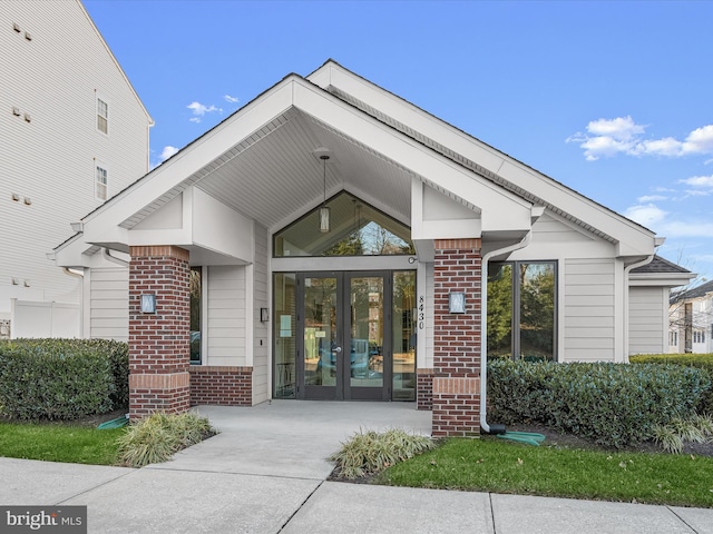 view of exterior entry featuring french doors