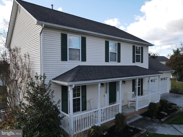 view of front of property featuring a garage and covered porch