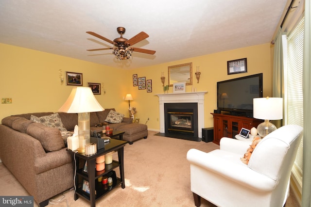 living room with a textured ceiling, light colored carpet, and ceiling fan