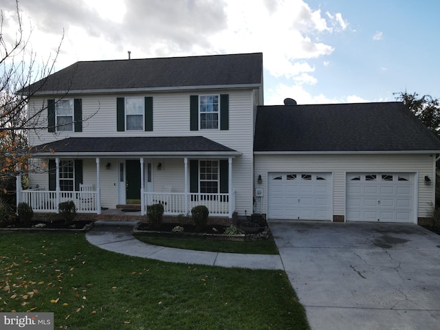 view of front of house with a porch, a front yard, and a garage