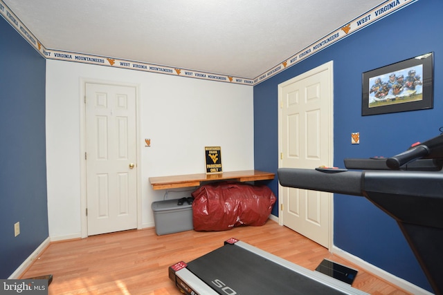 exercise area featuring hardwood / wood-style flooring