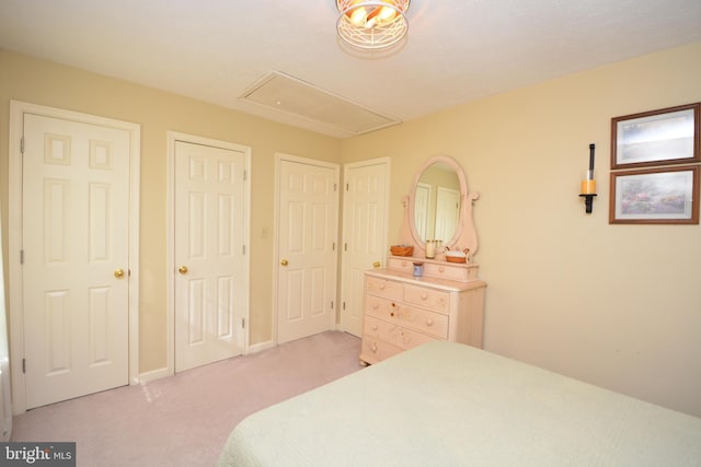 carpeted bedroom with two closets