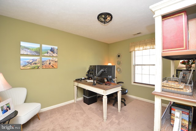 office area featuring light colored carpet and a textured ceiling