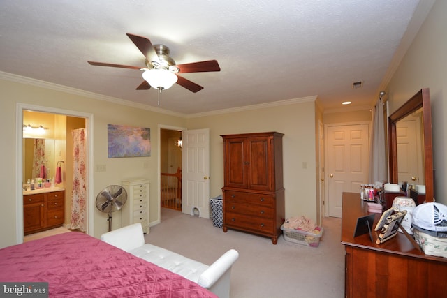 carpeted bedroom featuring a textured ceiling, crown molding, ceiling fan, and ensuite bath