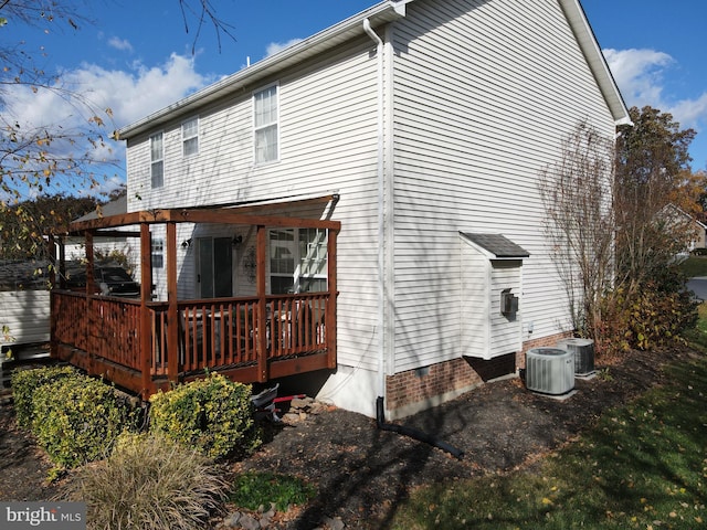 rear view of house featuring central air condition unit and a deck