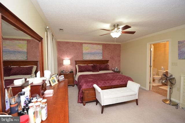 bedroom featuring ornamental molding, ensuite bathroom, ceiling fan, a textured ceiling, and light colored carpet