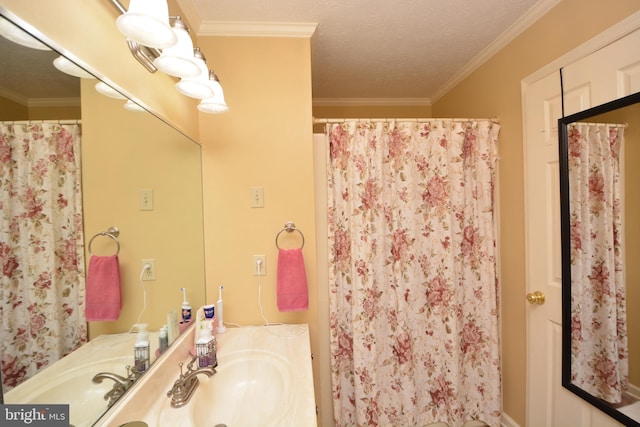 bathroom with vanity, a textured ceiling, and ornamental molding