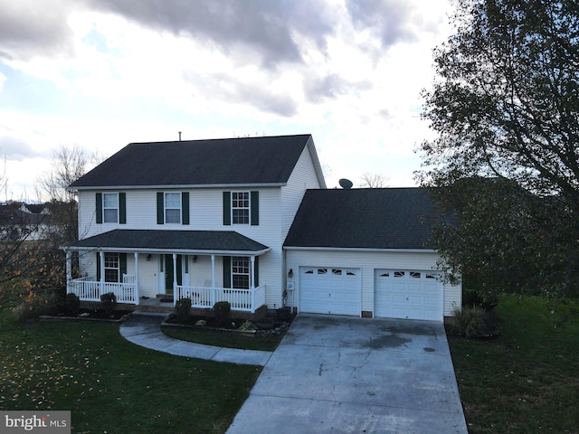 view of front facade with a garage, a front yard, and covered porch