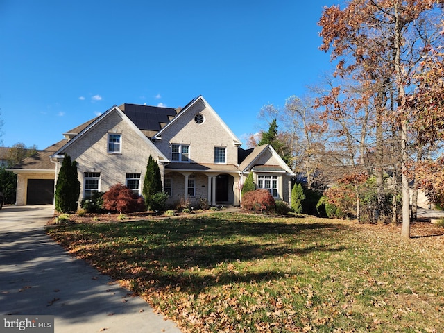 view of front facade featuring a front yard and a garage