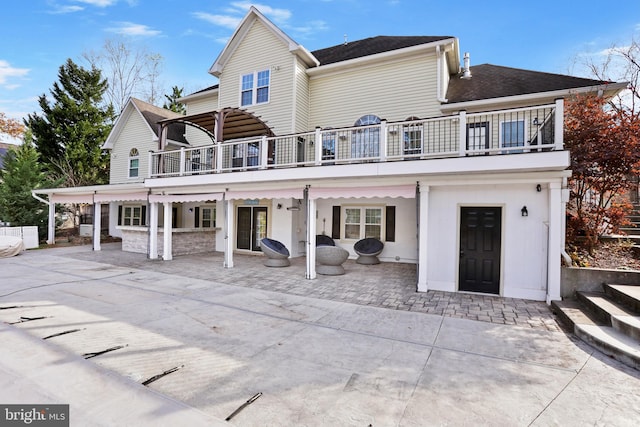 back of property with a patio area and a balcony