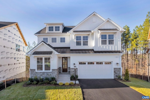 craftsman inspired home featuring a garage and a front yard