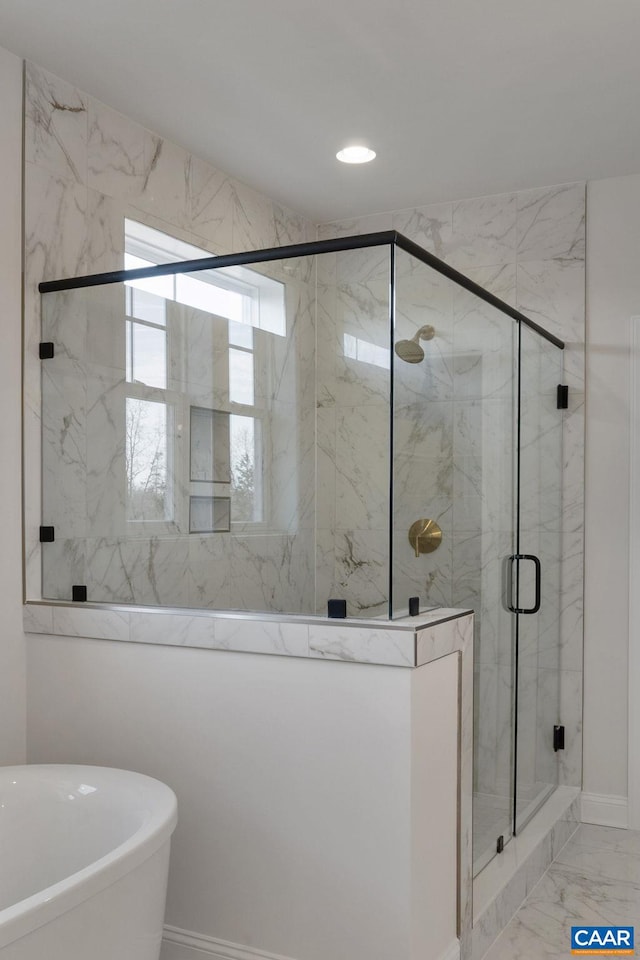 bathroom featuring shower with separate bathtub