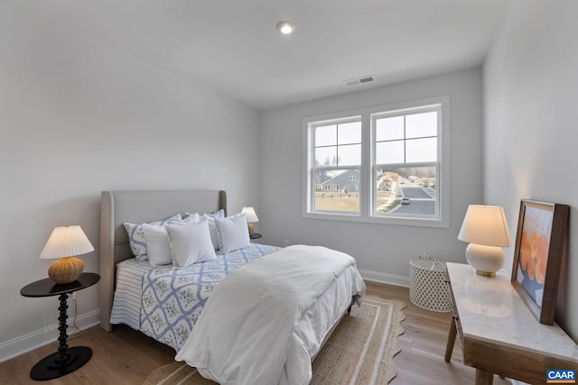 bedroom with hardwood / wood-style flooring