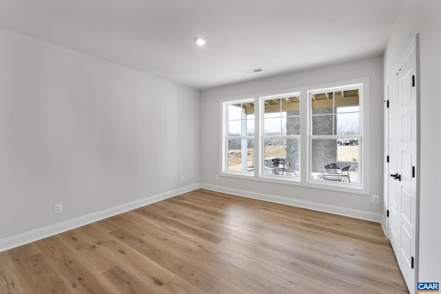 empty room with light hardwood / wood-style flooring