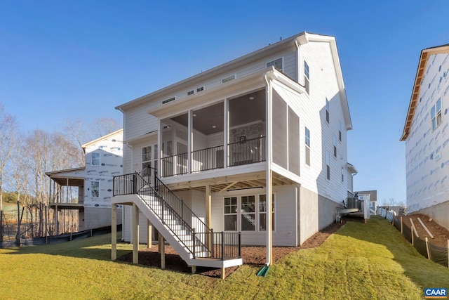 back of house featuring a sunroom and a yard