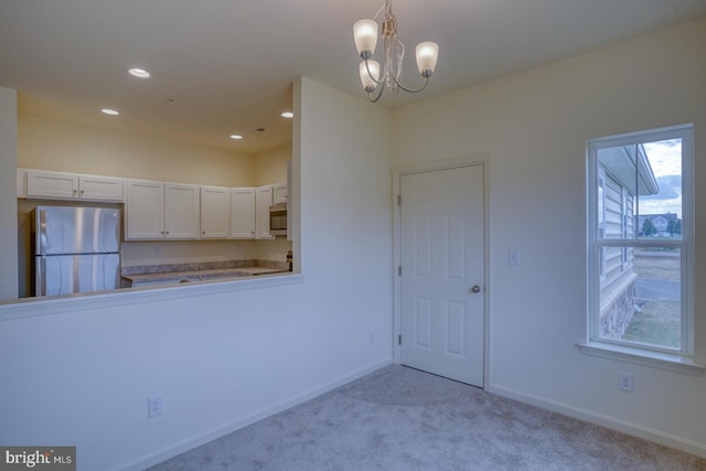 interior space with a chandelier and light colored carpet