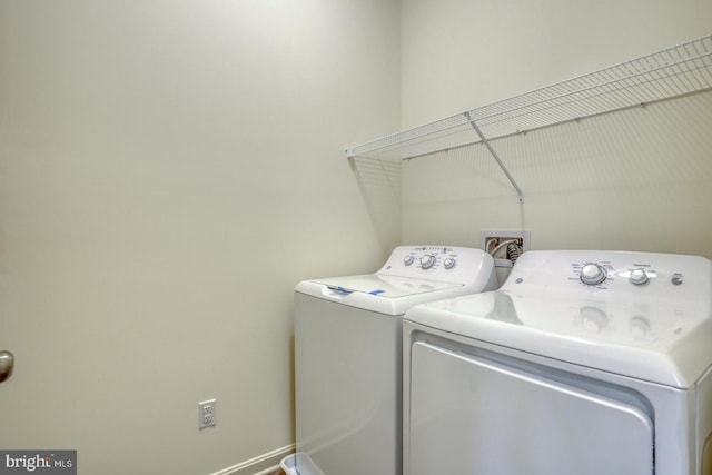 clothes washing area featuring separate washer and dryer