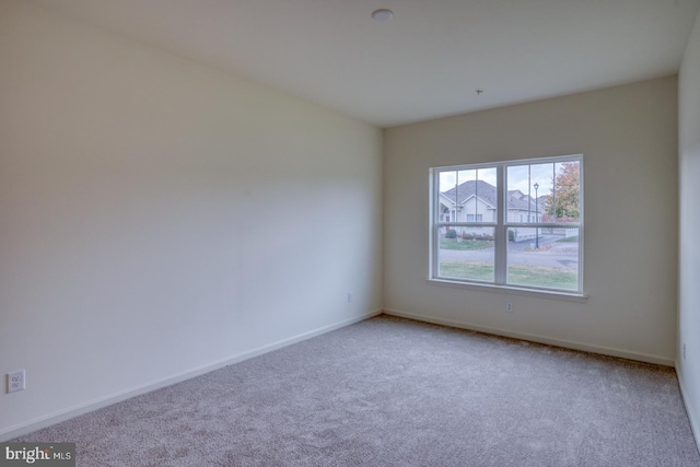 unfurnished room with light colored carpet