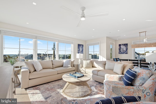 living room featuring ceiling fan and plenty of natural light