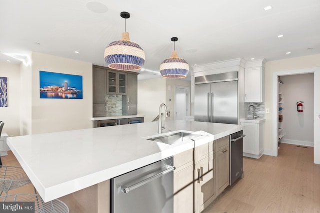 kitchen with decorative backsplash, light wood-type flooring, a large island, white cabinetry, and stainless steel appliances