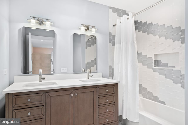 bathroom featuring shower / bath combo and vanity